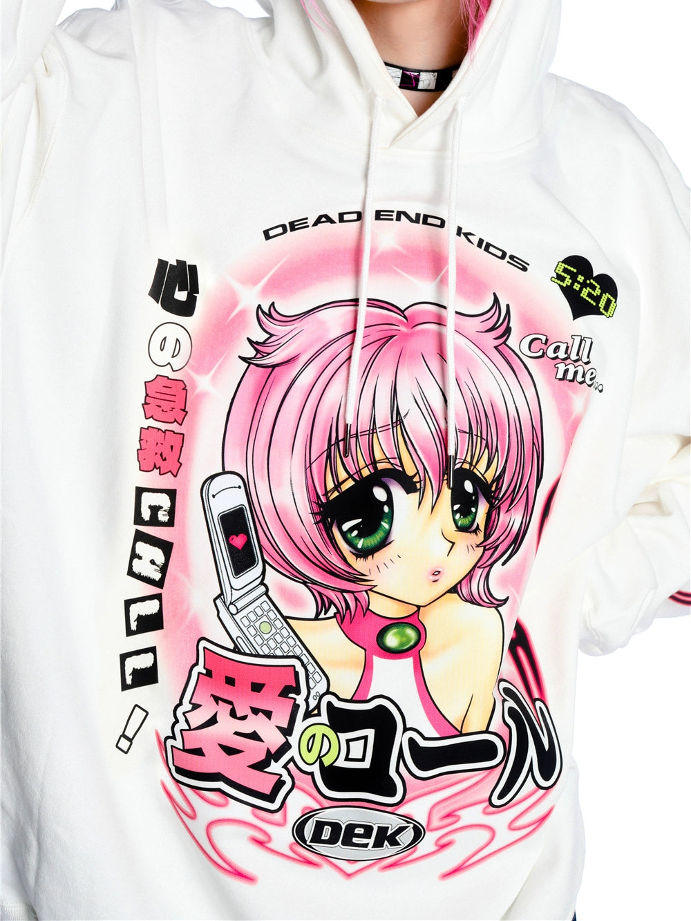 A person is wearing the Seakoff Y2K Aesthetic Anime Hoodie, featuring a kawaii white design with an anime character with pink hair and a flip phone surrounded by Japanese text and phrases like "Dead End Kids" and "Call me," highlighted by bold colors that enhance its Y2K style.