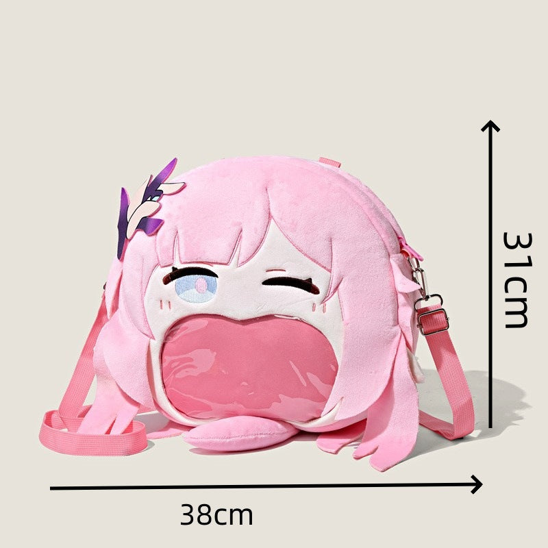The Seakoff Honkai Impact 3rd Seele Vollerei plush shoulder bag, inspired by the anime, features a cartoon character face with an open mouth pocket design. It measures 38cm wide by 31cm high and includes a pink strap and playful hair detail on the side.