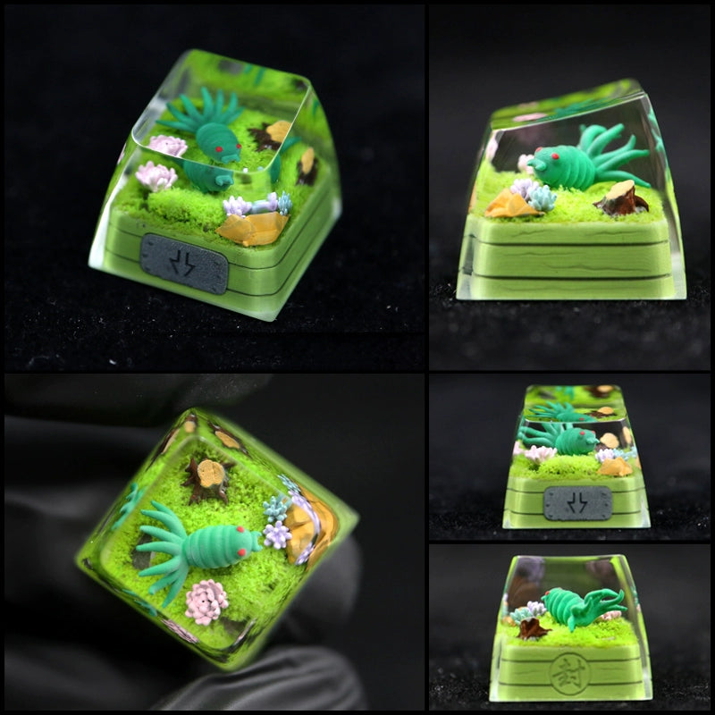 Images display a Naruto keycap featuring a Tailed Beast-like miniature green creature with plants. The transparent casing unveils intricate details like lush grass, flowers, and the creature from various angles. Part of the "Tailed Beasts Naruto Keycaps" collection, including Kurama, Shukaku, and Saiken.