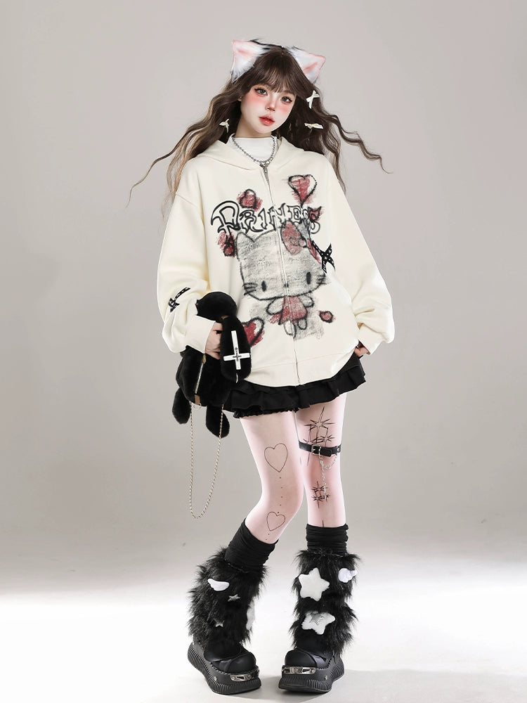 A person embraces kawaii fashion, standing against a plain background in cat ear headbands and the Seakoff Gothic Hello Kitty Princess Hoodie—an oversized zip-up with edgy heart and cross graphics. They pair it with a black skirt, furry leg warmers, hold a black stuffed toy, and wear leggings with various designs.