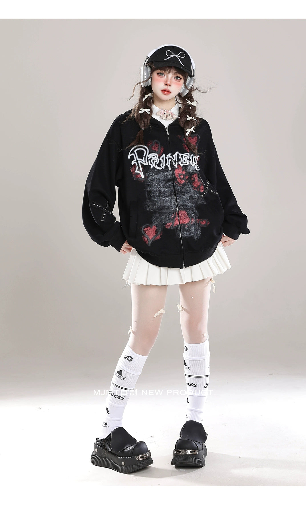 Dressed in a Seakoff Gothic Hello Kitty Princess Hoodie, a white pleated skirt, and black platform shoes, a person stands against a gray backdrop. Embracing kawaii fashion with long braided hair, they&