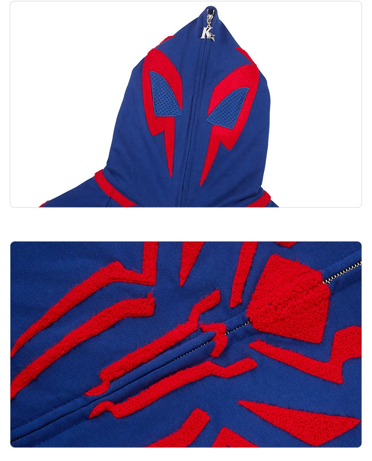 The Seakoff Superhero Spider Hoodie is a blue and red oversized zip-up sweatshirt with eye-like red shapes on the hood, black mesh insets, and a striking spider emblem on the chest. It&