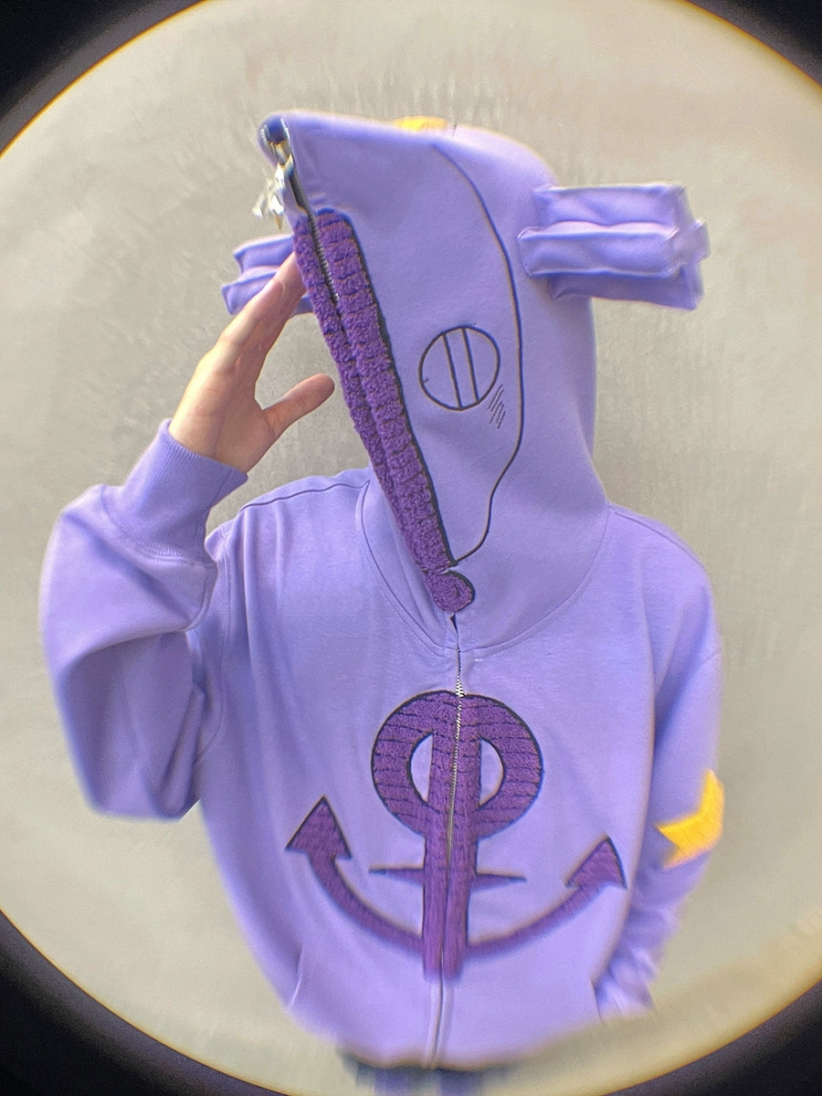 A person in a Seakoff Purple Symbol Hoodie, an oversized 400GSM anime zip-up sweatshirt, stands against a neutral background. This streetwear piece features star and ear designs with a large hood covering their face.