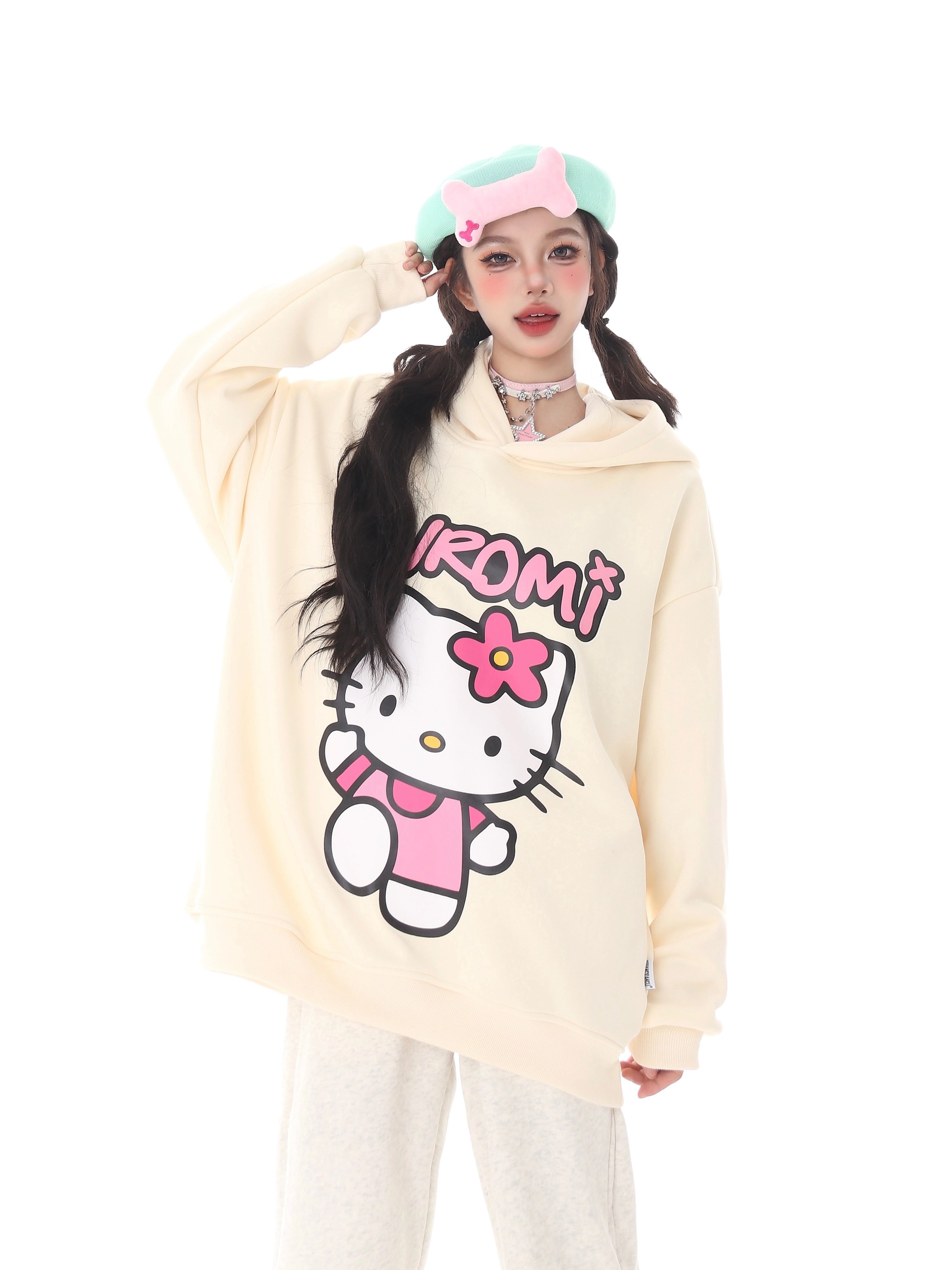 A person embodies kawaii fashion with a pastel green beret adorned with pink accents, a choker, and Seakoff&