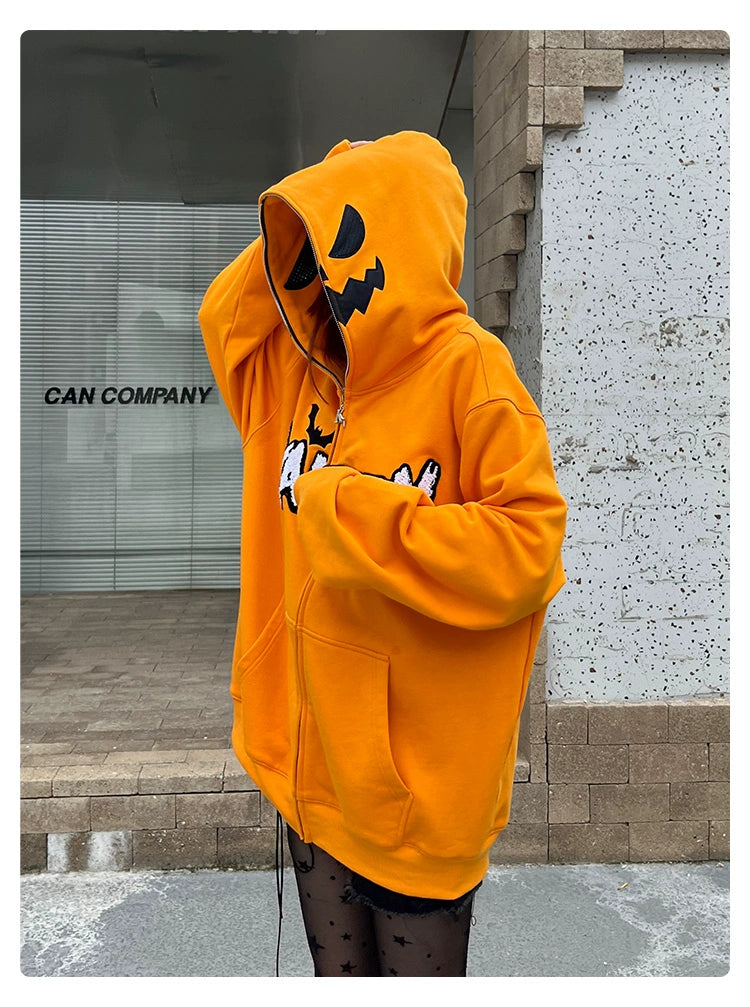A person dressed in the Seakoff Halloween Pumpkin Hoodie - an oversized 400GSM orange zip-up sweatshirt with a jack-o&