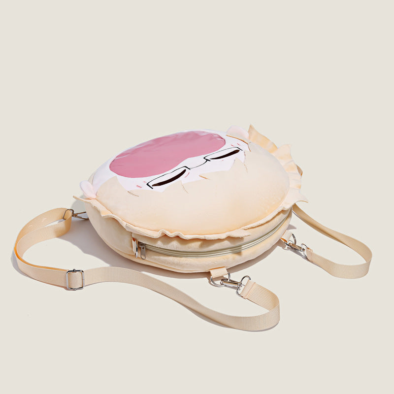 The Seakoff Haikyuu!! Tsukishima Kei Plush Shoulder Bag features a round design with a cute cartoon face, including glasses and a pink hair accent. It has a beige strap, an off-white background, and includes a fun transparent mouth pocket.