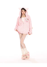 A person poses against a white background in their kawaii fashion, featuring the Seakoff Hello Kitty Pink Kawaii Hoodie—an oversized zip-up with a cat ear hood and all-over print—paired with white lace leggings and fuzzy pink slippers. The ensemble perfectly captures the essence of Sanrio characters.