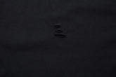 A sheet of black fabric with four small horizontal tears in the center, reminiscent of edgy anime streetwear, evokes the allure of a limited edition Death Note Long Sleeve Shirt by Death Note in black & gray gradient with distressed design and artistic hem.