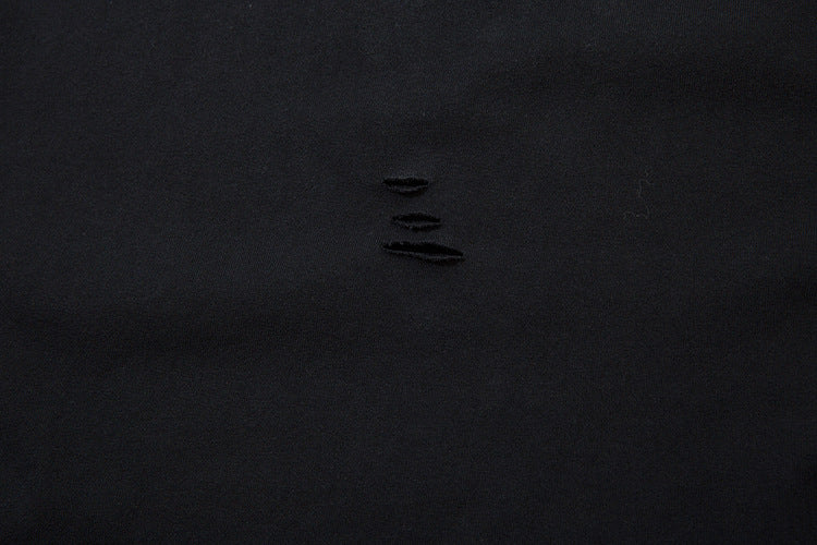 A sheet of black fabric with four small horizontal tears in the center, reminiscent of edgy anime streetwear, evokes the allure of a limited edition Death Note Long Sleeve Shirt by Death Note in black & gray gradient with distressed design and artistic hem.