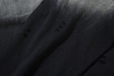 Close-up of a limited edition Death Note long sleeve shirt featuring a black & gray gradient distressed design and artistic hem. The soft, slightly shiny texture and lighting emphasize the edgy anime streetwear style.