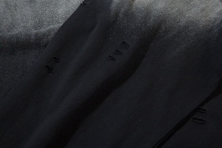 Close-up of a limited edition Death Note long sleeve shirt featuring a black & gray gradient distressed design and artistic hem. The soft, slightly shiny texture and lighting emphasize the edgy anime streetwear style.