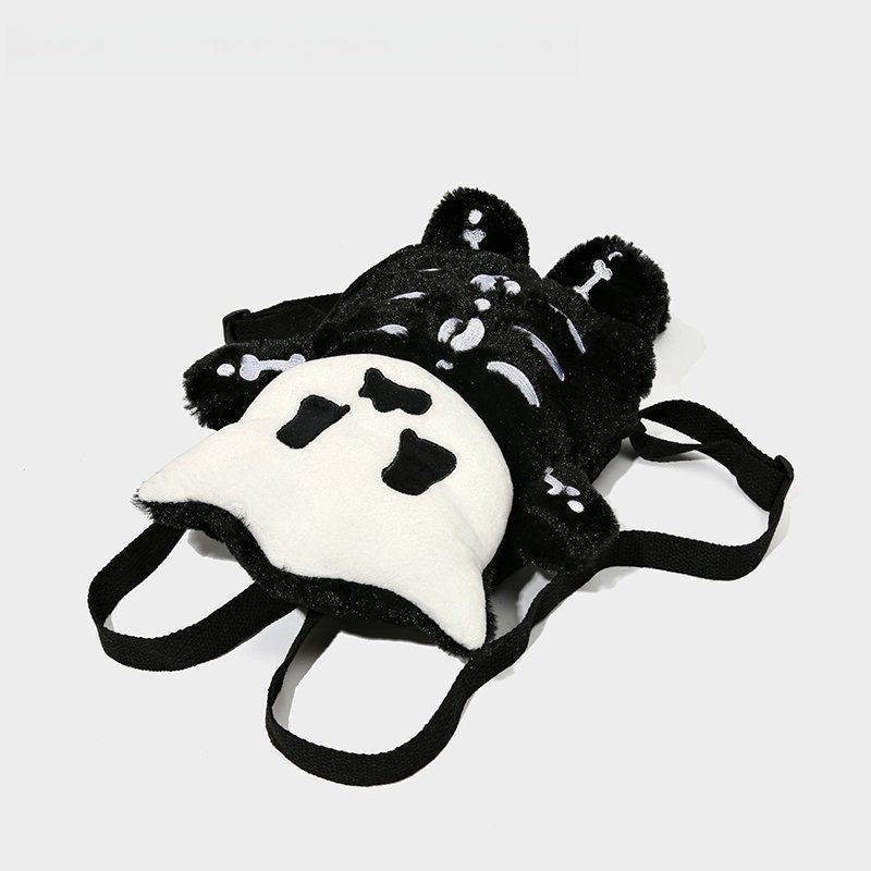 The Seakoff Spooky Skeleton Plush Backpack features a creepy-cute cartoon skeleton design on its back and plush black straps, making it the perfect Halloween accessory against a light gray backdrop.