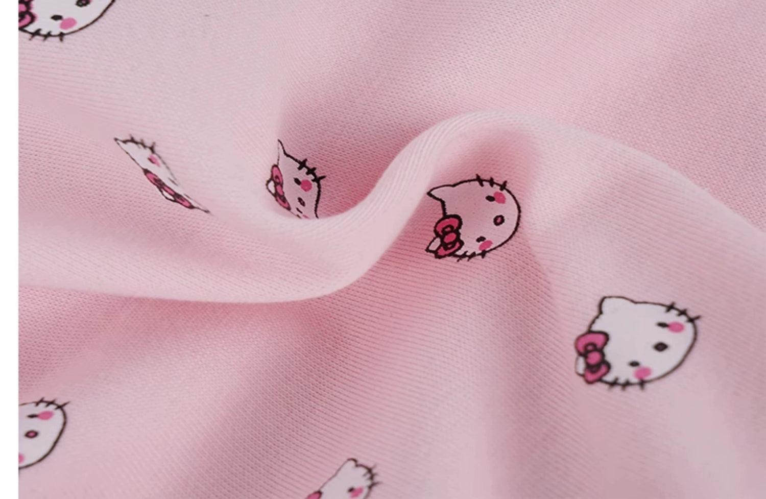 A close-up of pink fabric featuring small, cartoon cat faces with bows, showcasing the texture and playful pattern perfect for Seakoff&