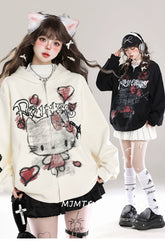 Two individuals in Seakoff Gothic Hello Kitty Princess oversized zip-up hoodies with heart and cross graphics sport pleated skirts, knee-high socks, and chunky shoes. One wears cat ears; the other has headphones. They stand against a plain white backdrop, showcasing their unique alternative fashion.