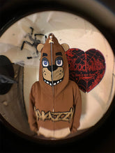 Someone sports a Seakoff Freddy-Inspired Hoodie, an oversized brown zip-up sweatshirt reminiscent of Five Nights at Freddy&