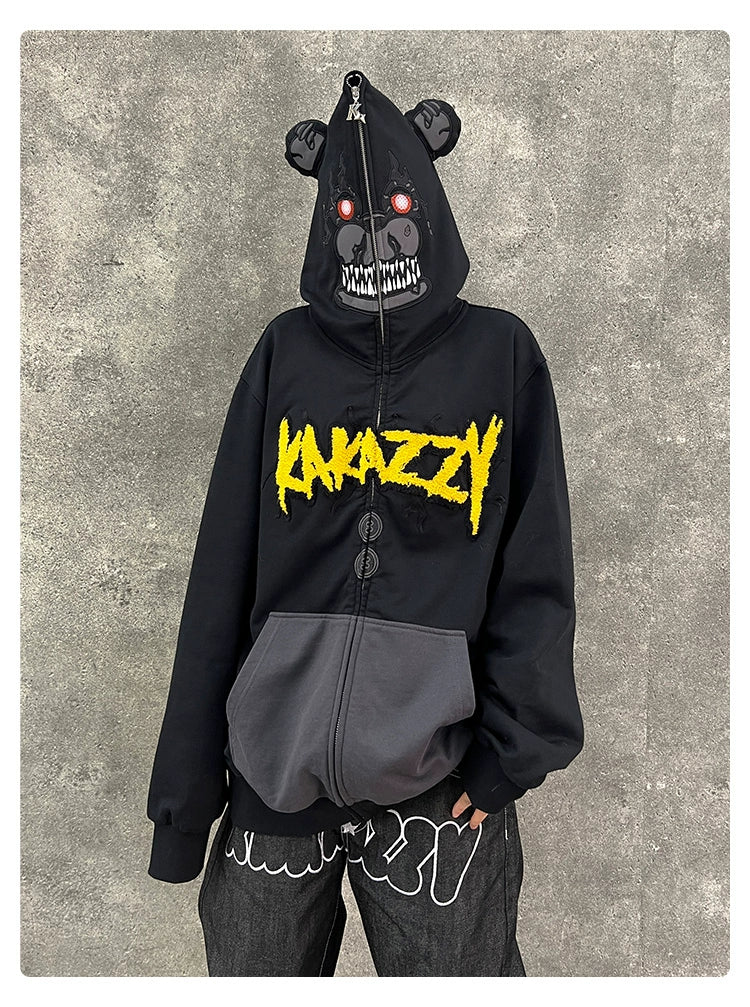 A person wears the Seakoff Dark Bear Demon Hoodie, made from 400GSM cotton, featuring a bear face with red eyes and fangs. "KAMAZZY" is in yellow above large pockets. It&