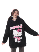 A person in a Seakoff Kawaii Hello Kitty Oversized Hoodie with Kuromi from Sanrio sports a kawaii look. They have long dark pigtails, a pink headband, choker, and gray jeans—ideal for true Sanrio fans.