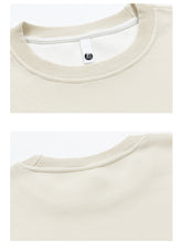 Close-up images of the SEAKOFF Limited Edition Dragon Ball sweatshirt in beige. The top image shows the front neck with a white tag and black button, while the bottom highlights back neck stitching and ribbed texture reminiscent of Goku&
