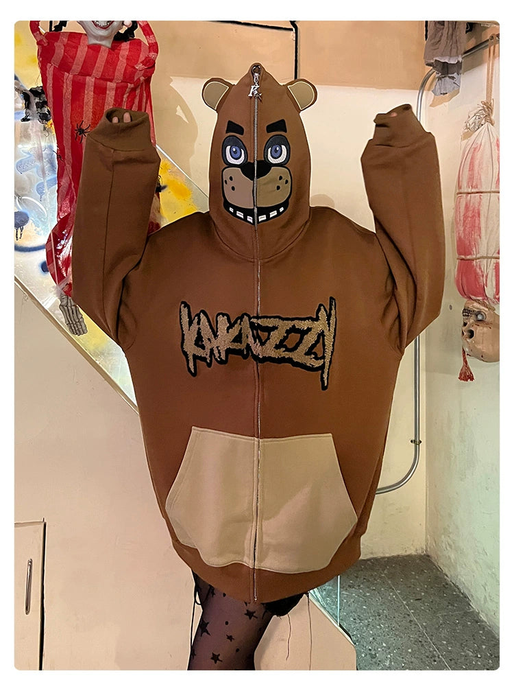 A person wears the Seakoff Freddy-Inspired Hoodie—an oversized brown zip-up Five Nights at Freddy&