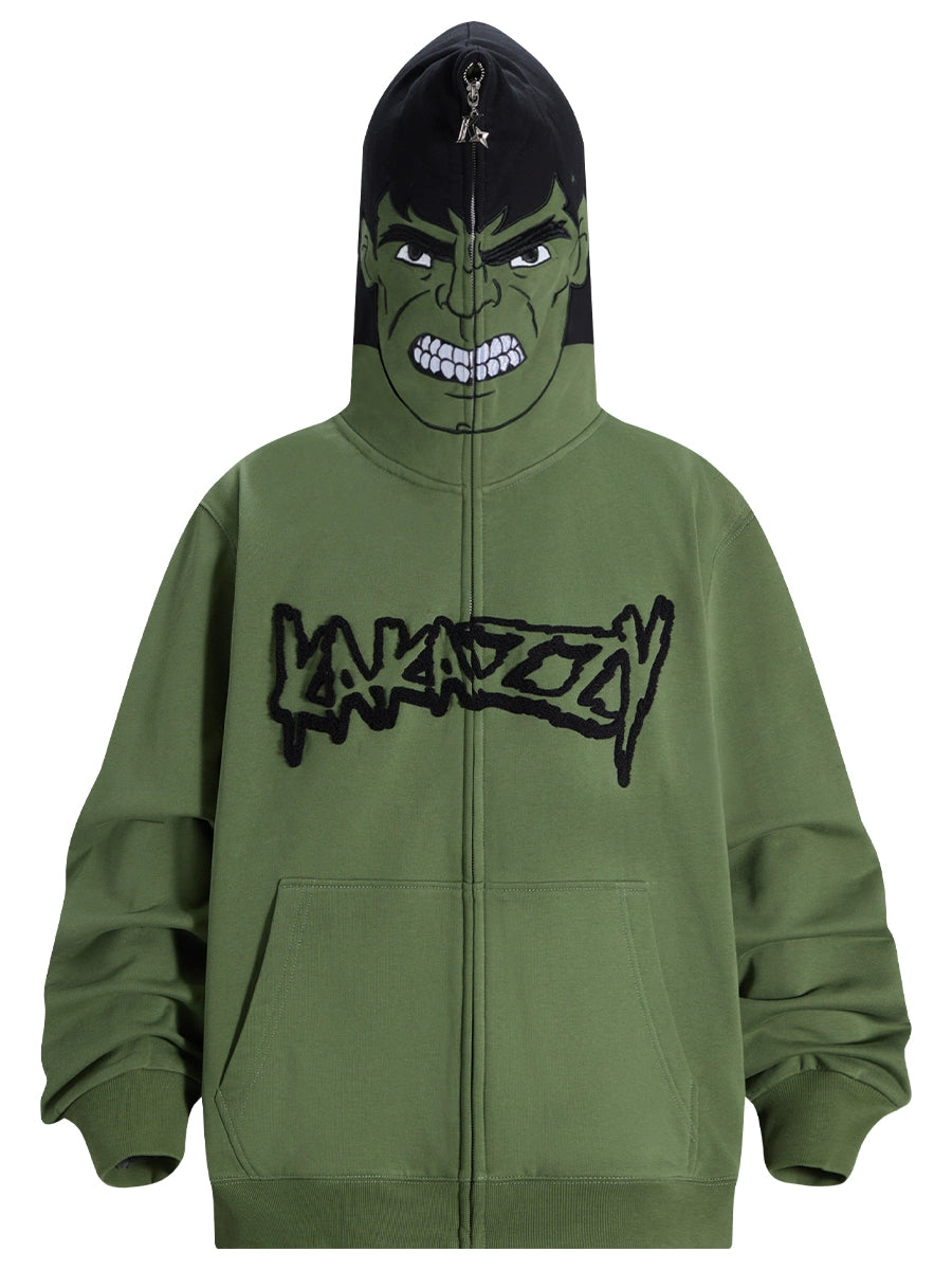 The Hulk-Inspired Hoodie by Seakoff is a 400GSM oversized green zip-up sweatshirt featuring a cartoon-like angry face and "LAKAZOOY" in stylized letters. Perfect for superhero fans and streetwear lovers, it delivers a fierce look ideal when zipped up.