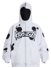 The Seakoff Monochrome Ink Splatter Hoodie is a 400GSM oversized white and black zip-up streetwear sweatshirt featuring "UNKNOWN" in graffiti style on the chest. It includes a full-cover black face mask with eye openings.