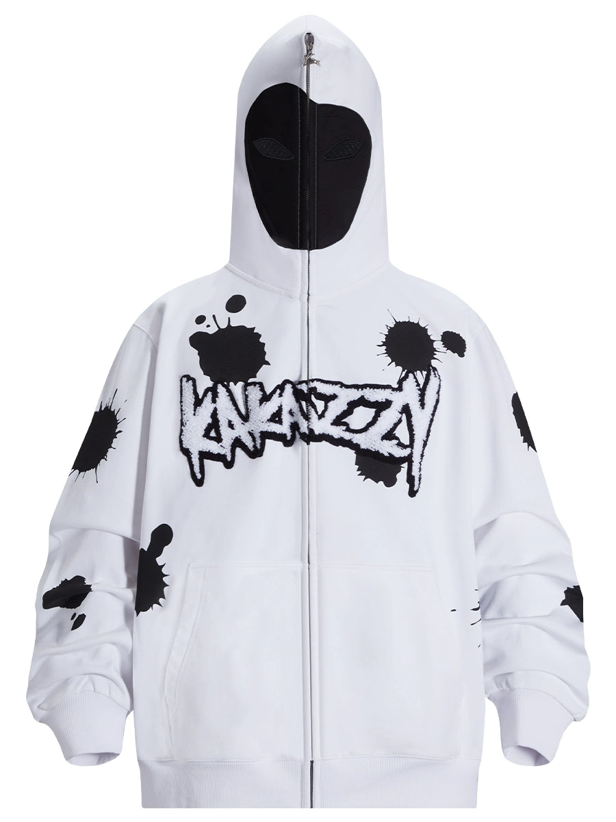 The Seakoff Monochrome Ink Splatter Hoodie is a 400GSM oversized white and black zip-up streetwear sweatshirt featuring "UNKNOWN" in graffiti style on the chest. It includes a full-cover black face mask with eye openings.