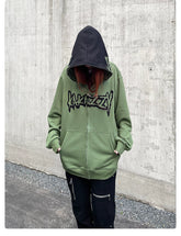 A person stands against a concrete wall wearing Seakoff&