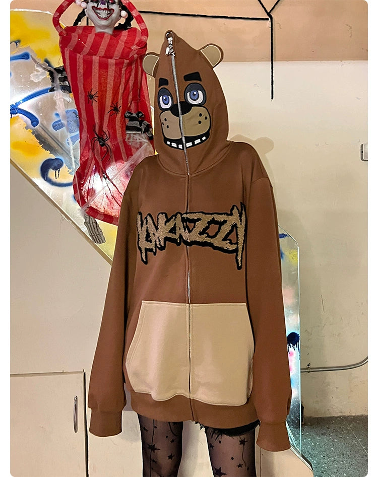 A person is wearing a Seakoff Freddy-Inspired Hoodie, a 400GSM oversized brown zip-up resembling a bear from Five Nights at Freddy&