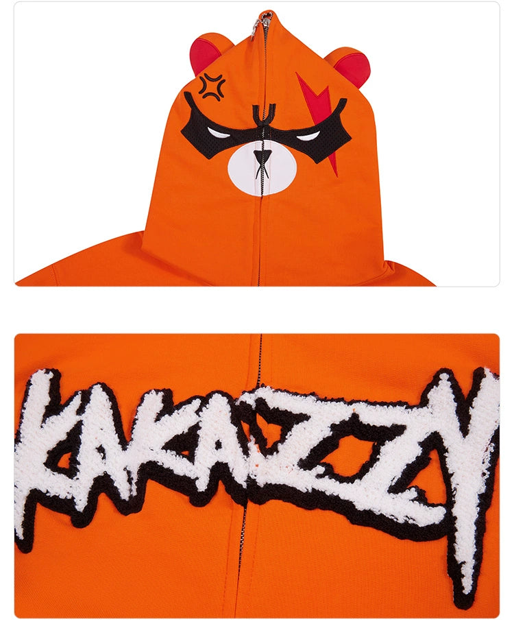 The Seakoff Furious Orange Bear Hoodie is made from premium 400GSM cotton and features a zip-up hood with cartoon bear ears, an angry bear face design, and "KAKAZZY" boldly emblazoned on the back in red embroidery, offering both uniqueness and comfort.
.