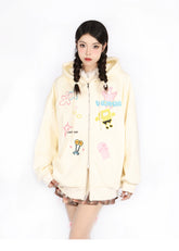 Wearing a Kawaii Pastel Cartoon Hoodie by Seakoff, featuring playful embroidered designs like a jellyfish and robot, a person with braided hair poses seriously in plaid skirt and stockings on a white backdrop.