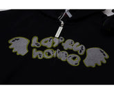 The Seakoff Cute Night Fury Dragon Hoodie is an anime-inspired full zip hoodie in black, featuring an embroidered "lapful home" text with green outlines and grey wing-like patches. Perfect for anime fans, this hoodie also includes 3D ears and a toy accessory.