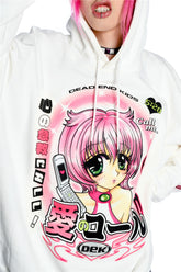 A person with pink hair wears the Seakoff Y2K Aesthetic Anime Hoodie, featuring a pink-haired anime character with green eyes and a kawaii phone. The design includes Japanese and English text, along with "DEAD END KIDS" in a retro manga style.