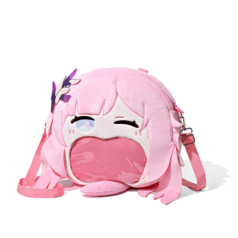 The Seakoff Honkai Impact 3rd Seele Vollerei Plush Shoulder Bag is a whimsical pink anime design with large eyes, long hair, and a transparent mouth pocket. It features a decorative purple detail on the left and an adjustable strap for easy carrying.