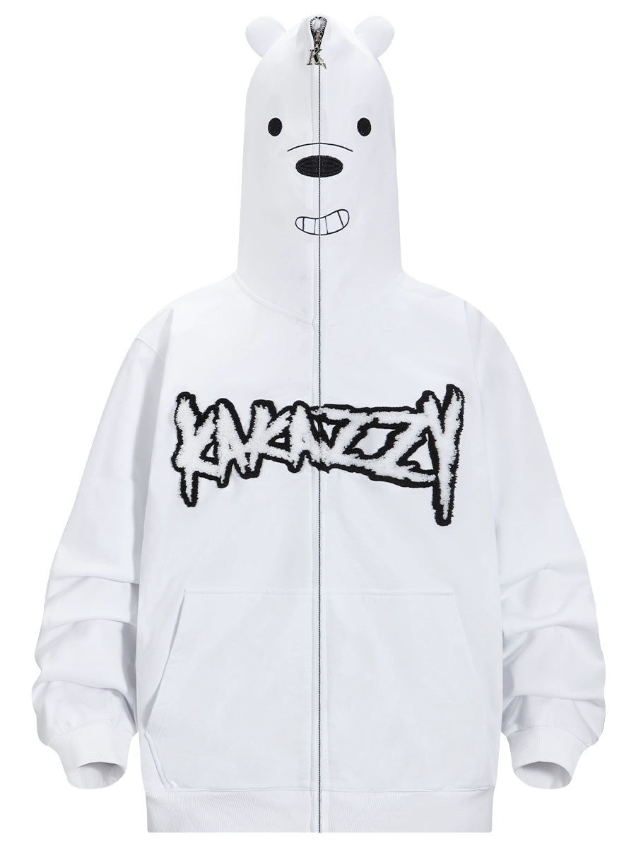 The Seakoff Cute White Bear Hoodie features a charming polar bear hood with a black nose, ears, and smile. Its oversized fit highlights bold graffiti-style "XAKAZZY" text on the front in black embroidery. Made from 400GSM fabric for comfort and style.