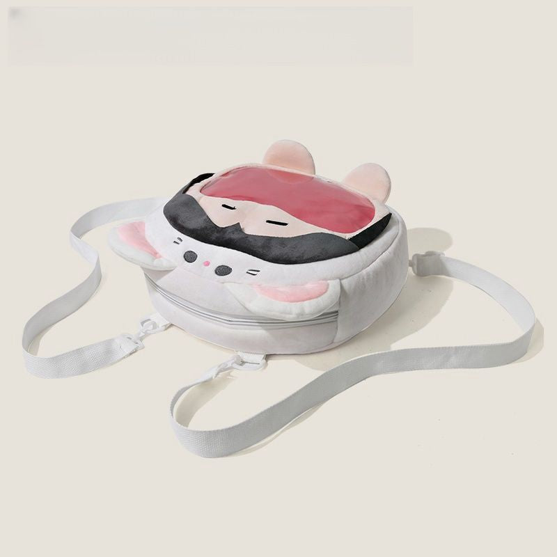 The Seakoff "Adorable Cat Hoodie Plush Bag" features a round design resembling a sleeping cartoon character with floppy ears, a pink mask, white adjustable straps, and a front zipper. Perfect for adding cuteness to your style!.