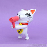 The Dandadan Lucky Cat PVC Figure, a cute 9.5 cm kawaii toy, features a white cat with a brown patch and yellow medallion holding a pink hairdryer. Perfect for anime collections, it stands charmingly against a purple background.