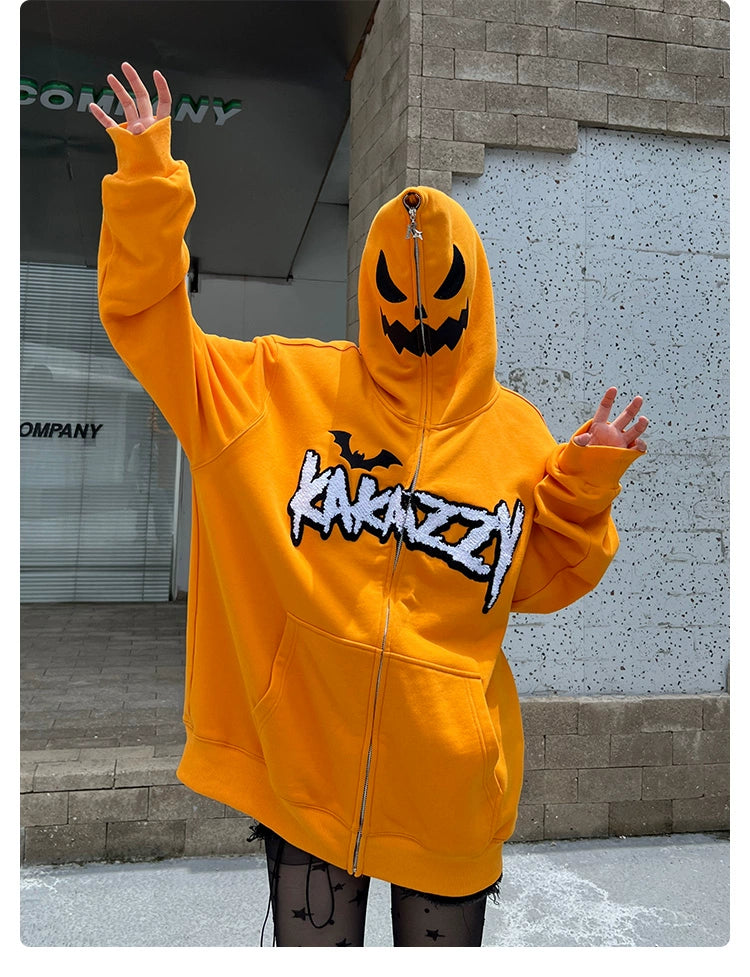 A person in a Seakoff oversized Halloween Pumpkin Hoodie, featuring an orange design with a jack-o&
