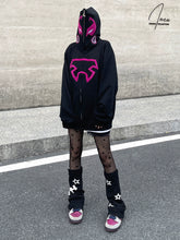 A person stands on a street, wearing Seakoff&