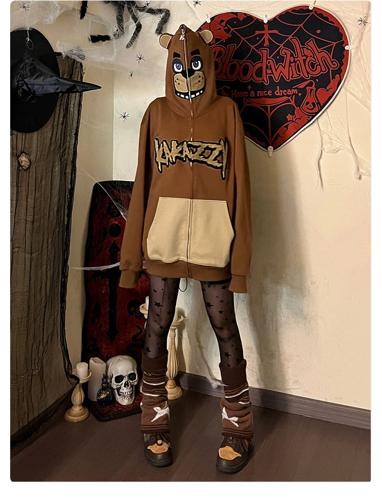 Someone wears a Seakoff Freddy-Inspired Hoodie, patterned tights, and skeleton leg warmers. The room is set for horror game fans with Halloween decor: cobwebs, a skull, a "Blood Witch" sign, plus a witch hat and broom are seen.
