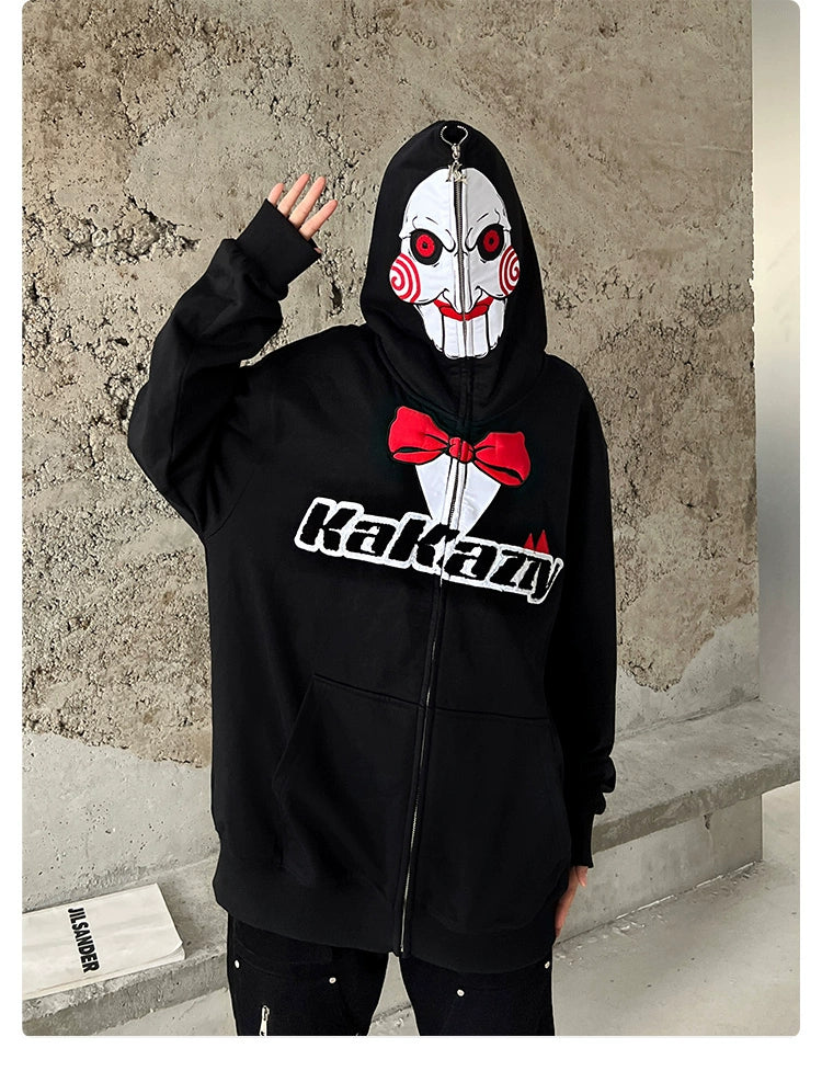 A person wears the Seakoff Saw-Inspired Hoodie—a 400GSM oversized black zip-up sweatshirt featuring Billy the Puppet&