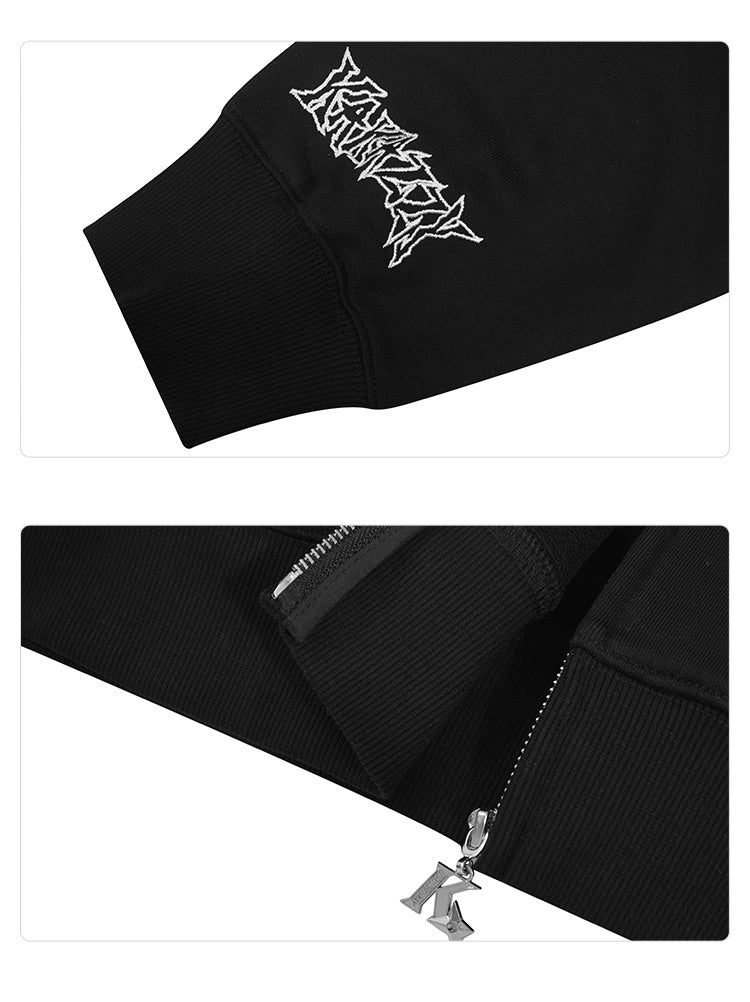 Close-up of a Seakoff Venom-Inspired Hoodie in black, featuring white, stylized sleeve text. A metal zipper with "K" charm adorns the lower section. The 400GSM cotton fabric has a ribbed texture.