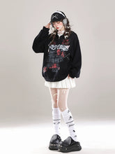 Sporting the Seakoff Gothic Hello Kitty Princess Hoodie, an oversized zip-up with edgy heart and cross graphics, a person pairs it with a pleated white skirt, knee-high socks, chunky platform shoes, headphones, and a bow-accented black cap amidst scattered feathers for kawaii flair.