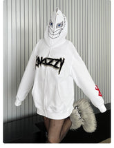 Wearing a Berserk Griffith-Inspired Hoodie, an oversized 400GSM white zip-up anime sweatshirt with "ARIEZZY" across the front and red sleeve design while standing against a striped wall, this person showcases furry-accented footwear—a perfect style for Berserk fans.