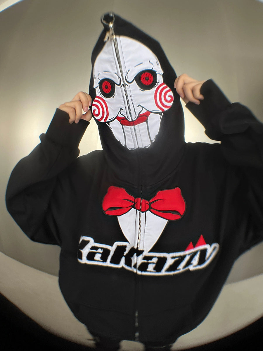 A person is wearing a Seakoff Saw-Inspired 400GSM Oversized Black Zip-Up Hoodie. Featuring Billy the Puppet&