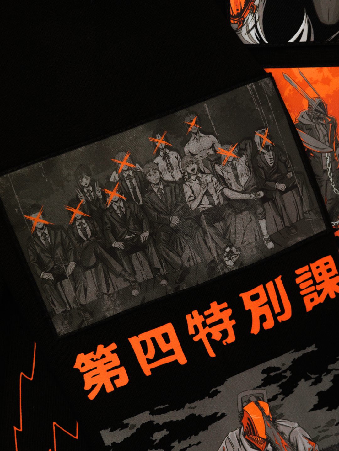 Illustration of people in dark suits with red X marks over their faces sits alongside text in Japanese, blending orange and black tones. The comic book style evokes anime fashion trends akin to the Chainsaw Man Hoodie – a stylish drop shoulder sweatshirt made from high-quality 360 GSM cotton by Chainsaw Man.