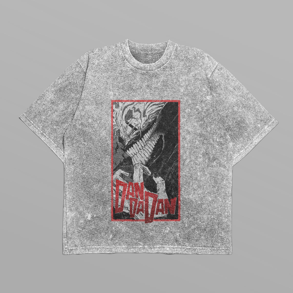 The Dandadan Monochrome Oversized T-Shirt features a gray acid-washed look with a dynamic Okarun graphic in black and white, framed by red. Bold "Dan Da Dan" text adds flair, making it ideal for anime streetwear fans.