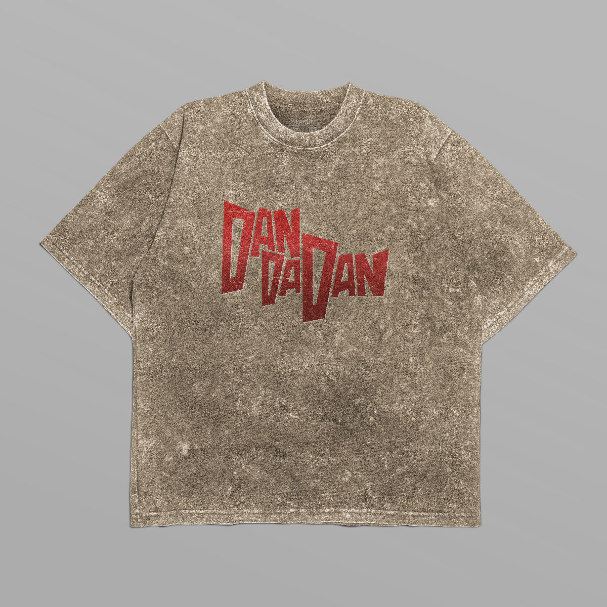 A gray speckled Dandadan Oversized T-shirt with "Dan Da Dan" in bold red on the front offers anime-inspired streetwear vibes. Displayed on light gray, its oversized fit provides comfort and style for casual outings. Made of 250 GSM cotton, it also features a back character group design.