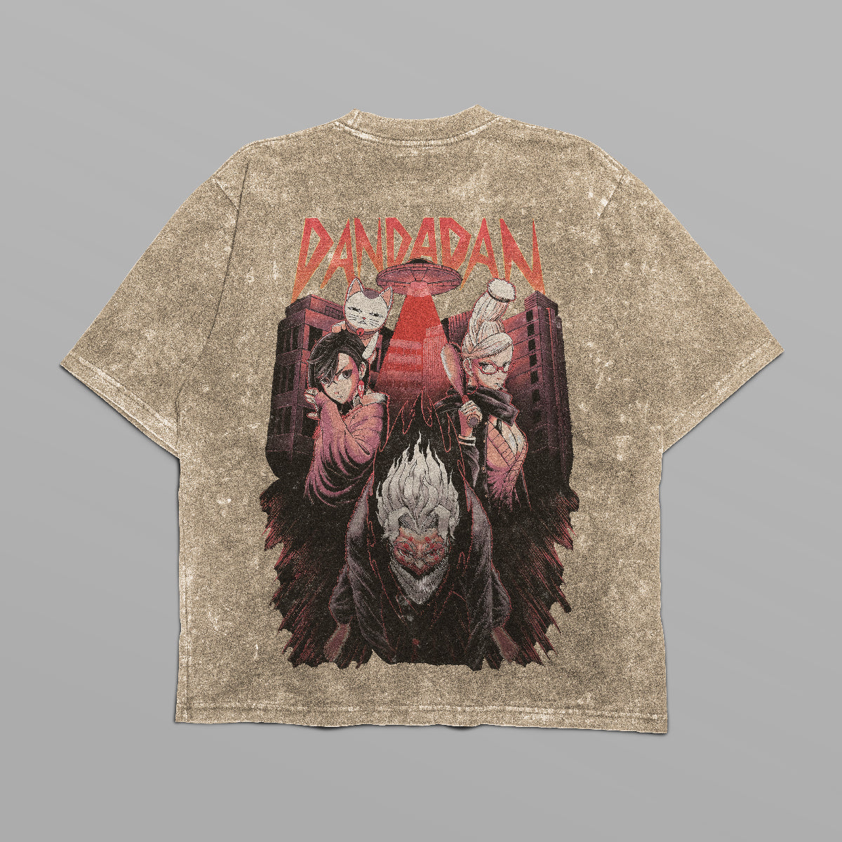 This oversized Dandadan T-shirt is anime-inspired streetwear featuring a colorful back graphic of three characters with bold red "Dandadan" text above, set against a cityscape, made in 250 GSM cotton.