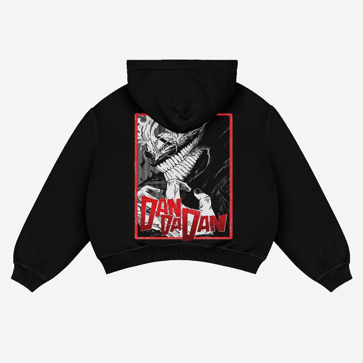 The Dandadan Hoodie by Dandadan features a black unisex streetwear design with a stylized manga panel graphic of a creature with sharp teeth, enclosed in a red-bordered rectangle. "DAN DA DAN" is boldly printed below the image, crafted from 360 GSM premium cotton for manga enthusiasts.