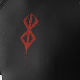 The Berserk Minimalist Anime Symbol Compression Gym Shirt features a black textured surface with a red, distressed, dripping design resembling interlocking diamonds and small splatters. This dynamic gym shirt combines anime-inspired style with high-quality moisture-wicking technology.